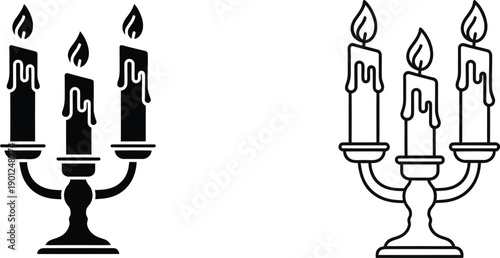 A pair of candelabras with candles on a white background