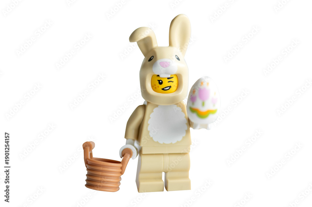 Fototapeta premium Lego minifigure Easter bunny with an egg and basket on a white background. 