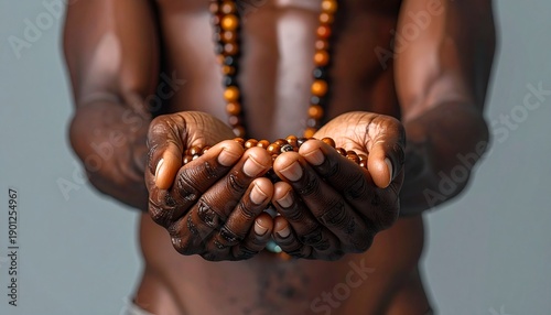 A person holding prayer beads in their cupped hands, conveying spirituality and contemplation