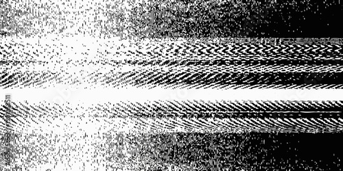 Abstract black and white textured image resembling tire tracks or patterns