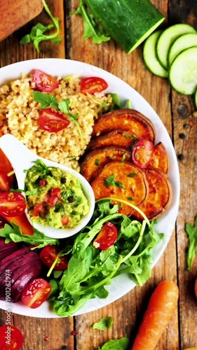 buddha bowl, vegetarian mixed salad with sweet potatoes. avocado, beetroot, cucumber and bulgur