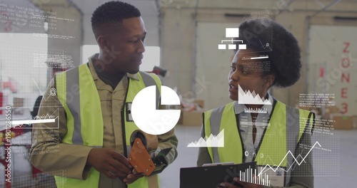 Checking two staff in safety vests comparing inventory data in packing bay with tape, clipboard