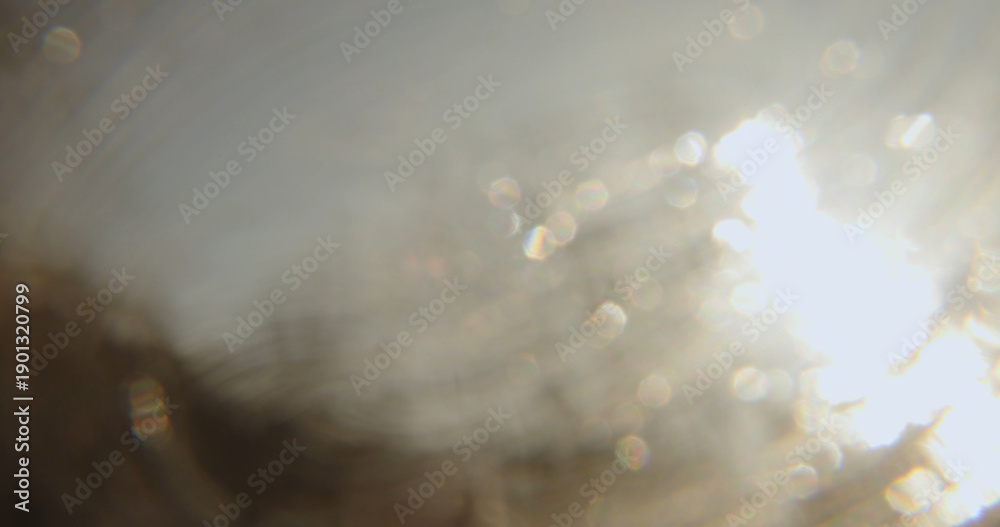 Fototapeta premium A soft, abstract blurred background with a smooth transition of light and shadows, creating the illusion of a blurred landscape through a window pane.