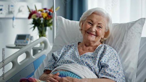 Senior woman smiling in a hospital bed while adjusting a colorful blanket. Elderly patient recovering in a medical ward. Healthcare and geriatric care concept
