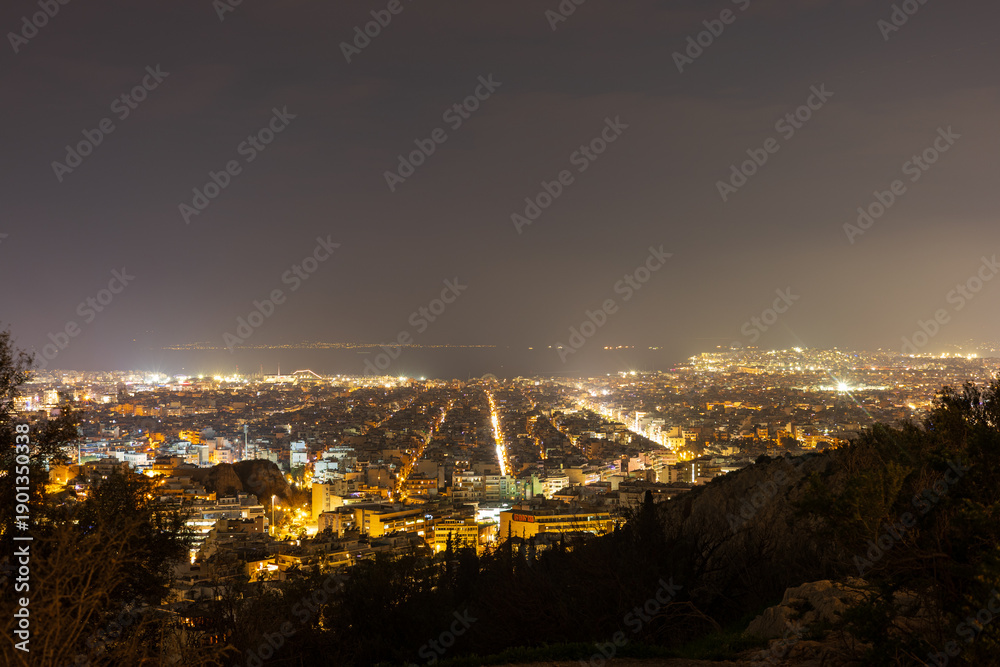 Fototapeta premium Athens City Night Panorama with Illuminated Streets, Greece