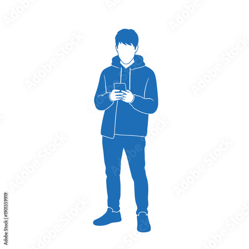 Young man standing and using smartphone outdoors alone