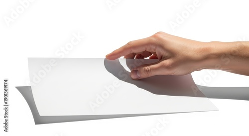 A hand turning a blank white sheet of paper on a white background with shadow