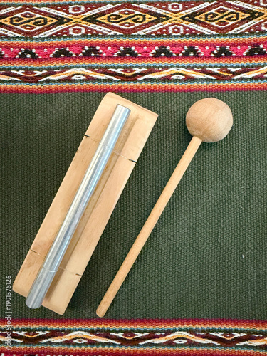 Handcrafted meditation and yoga musical instruments on ethnic textile background