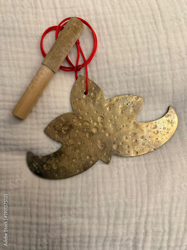 Handcrafted meditation and yoga musical instruments on ethnic textile background