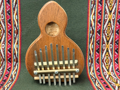 Handcrafted meditation and yoga musical instruments on ethnic textile background