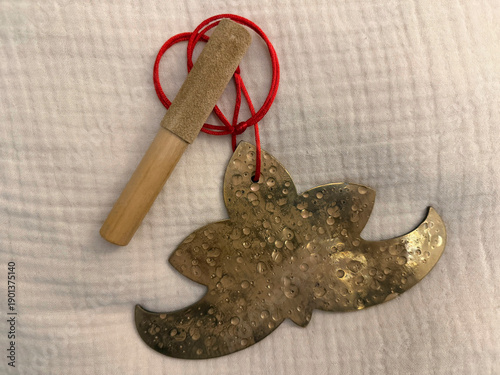 Handcrafted meditation and yoga musical instruments on ethnic textile background