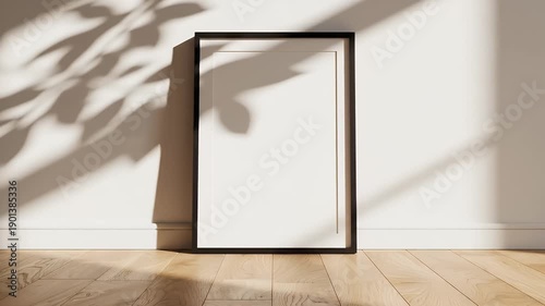 Minimalist Frame Mockup with Leaf Shadow - A minimalist black frame mockup stands against a white wall, with leaf shadows creating a natural, calming ambiance.