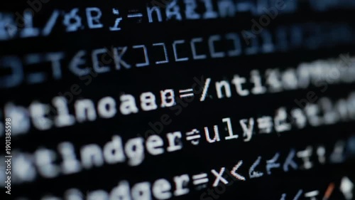 Extreme close-up video: bright white programming code appearing on a deep black digital screen with a blinking cursor, displaying intricate data processing. Concept of digital technology