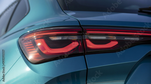 Close up of modern red LED tail lights on a teal luxury SUV showcasing sleek automotive design and futuristic lighting technology for premium vehicle branding projects