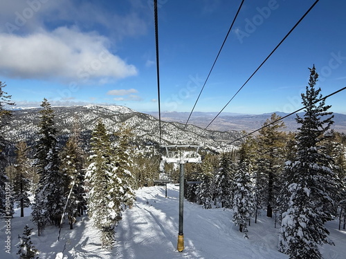 View from the chairlift of the trees and trails and Carson Valley on the ski slopes of Heavenly Ski Resort in Lake Tahoe in the winter