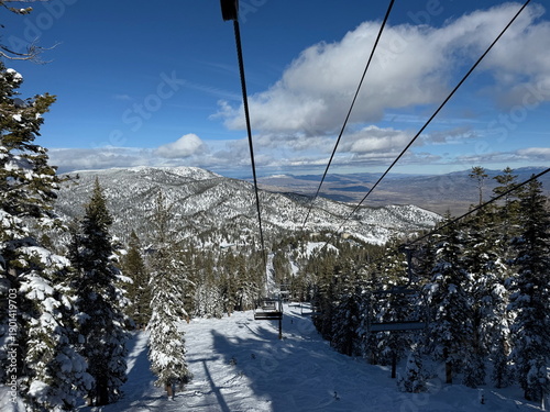 View from the chairlift of the trees and trails and Carson Valley on the ski slopes of Heavenly Ski Resort in Lake Tahoe in the winter