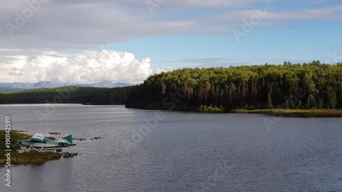 Alaska Fish Lake with beautiful seaplane, trees and clouds