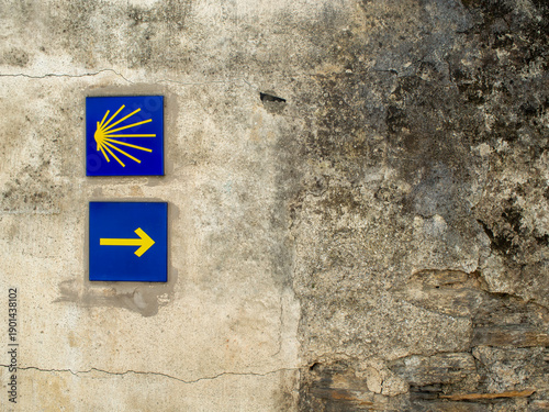 Pilgrimage Symbols: Traditional Yellow Arrow and Shell Marker on the Way of St. James
