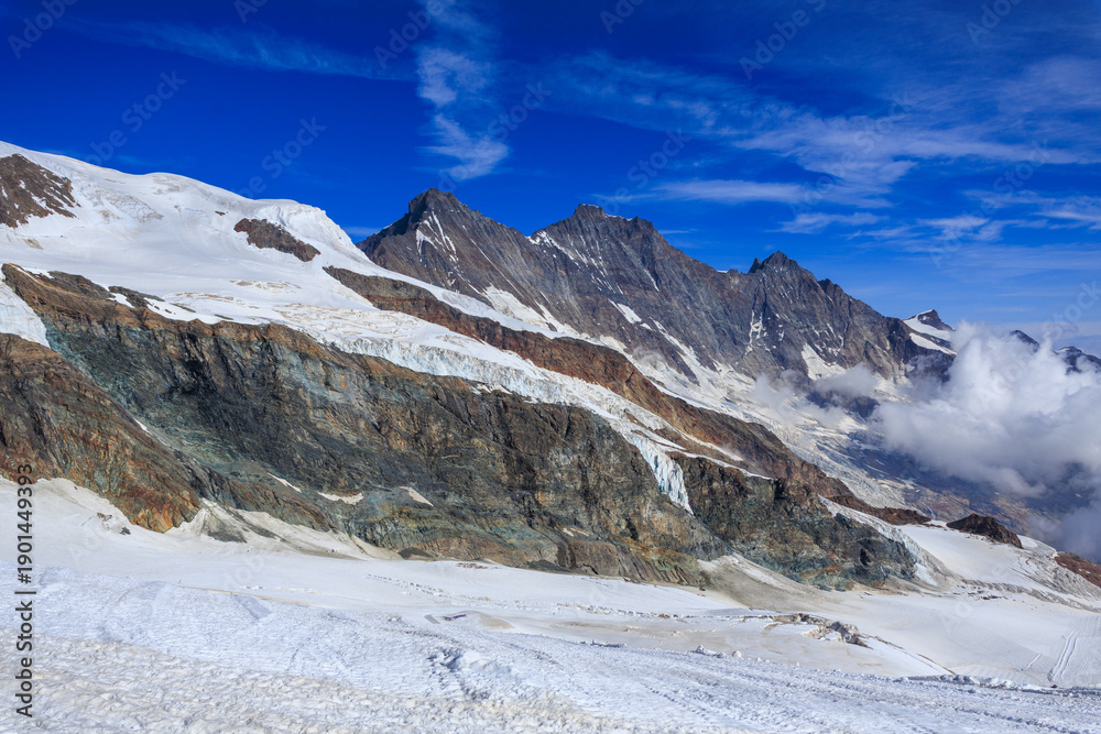 Fototapeta premium Mountain glacier panorama and summits Täschhorn, Dom and Nadelhorn (left to right) in summer in Swiss Alps, canton of Valais, Switzerland