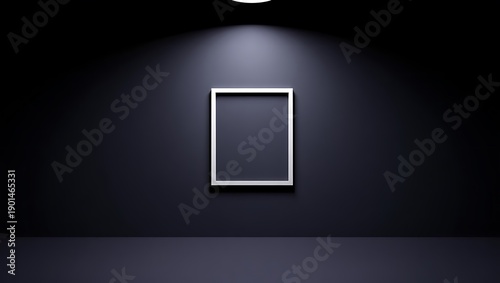 Empty minimalist white picture frame hanging on dark wall with focused spotlight creating dramatic contrast effect