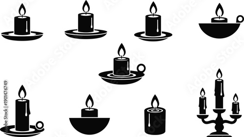 Black and white of lit candles on holders burning flame