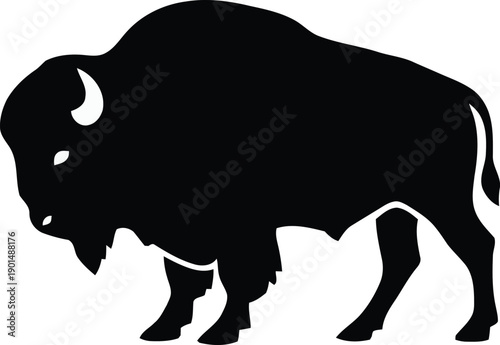 Monochrome silhouette of a bison, standing with head lowered, grazing.
