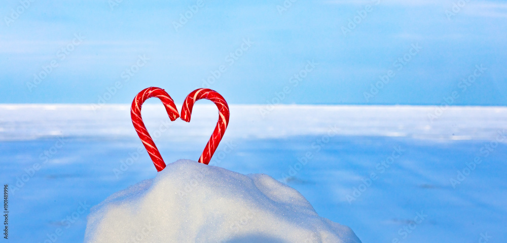 Fototapeta premium Candy heart on a frozen lake, endless snowy expanses, winter travel, I love winter background.