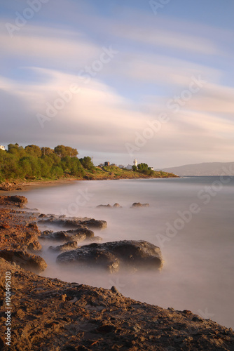 The most important warning for sailors is the lighthouse. The red historical lighthouse in Akyarlar, Bodrum, built in 1931, also showing the directions. Long exposure.