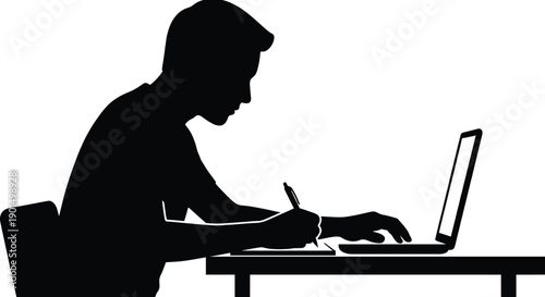 Student sitting at desk using laptop computer and writing notes in notebook side view silhouette