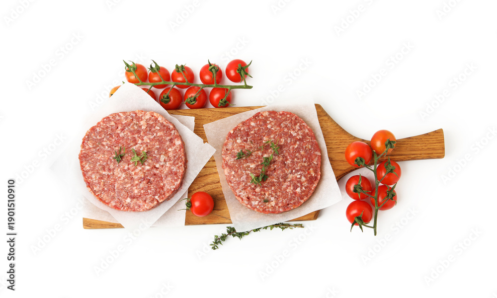 Naklejka premium Uncooked meat patty with thyme and tomatoes isolated on white, top view