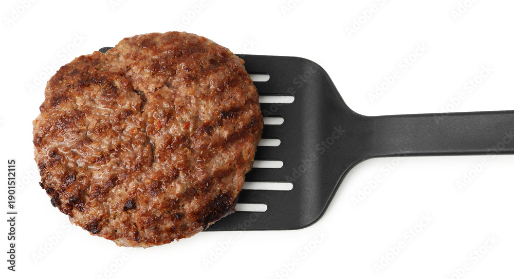 Fototapeta premium Spatula with delicious grilled meat patty isolated on white, top view