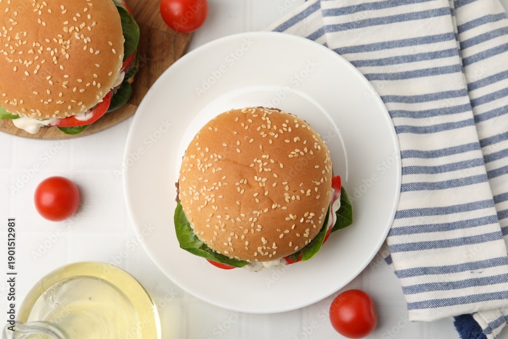 Fototapeta premium Delicious burgers with meat patties on white table, flat lay