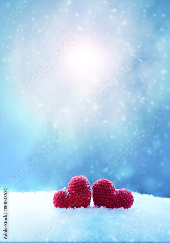 Happy valentines day background with two red hearts on white snow .