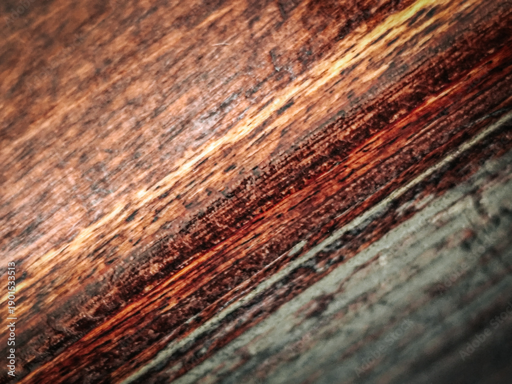 Fototapeta premium Close-up view of textured wooden surface showcasing rich brown and green hues with visible grain patterns and natural imperfections in a rustic style