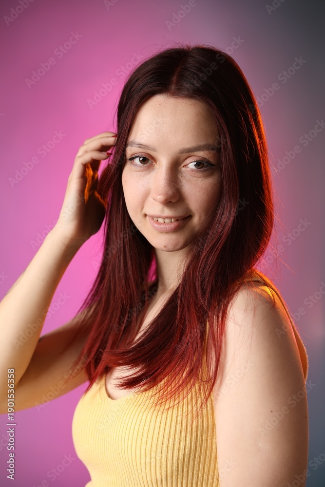 Fototapeta premium Woman with dyed hair on color gradient background