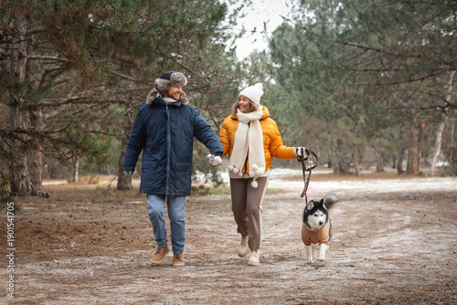 Young couple with Husky dog...