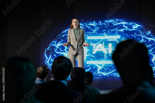 Konstfotografi Female business speaker leads futuristic AI-driven presentation with AI graphics, neural networks and deep learning concepts