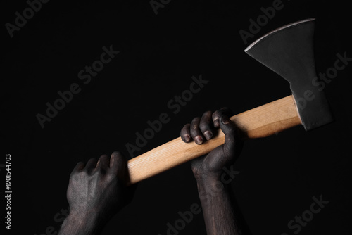 Hands in black paint holdin...