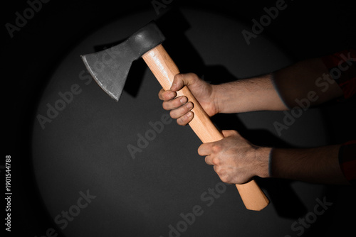 Hands with ax on black back...