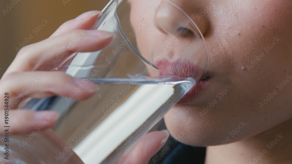 Fototapeta premium Close up female woman Asian Korean lips unrecognizable girl drinking clean water at home feeling thirsty morning hydration ritual holding glass healthy habit refreshment dehydration lifestyle drink