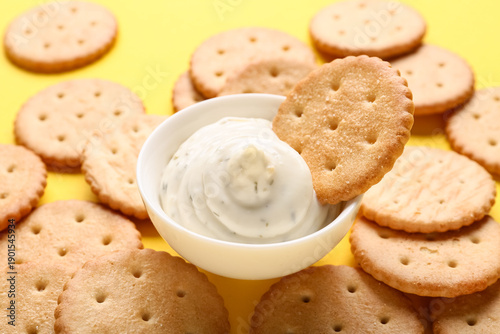 Tasty crackers with bowl of...