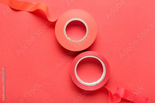 Adhesive tape rolls on red ...