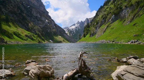 Peaceful mountain scene with shining lake and snowy peaks