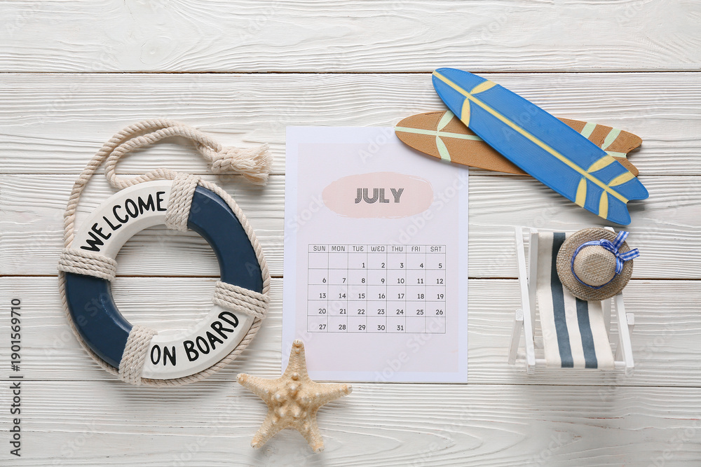 © Pixel-Shot - Calendar with beach decor on white wooden background. Summer vacation concept