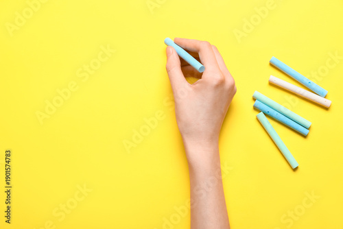 Hand holding blue chalk ove...