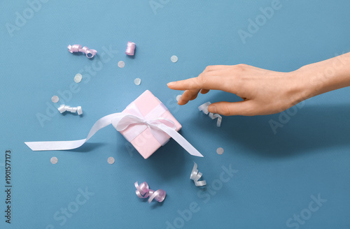 Female hand with pink gift ...