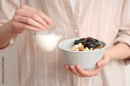 Woman pouring milk from jug...