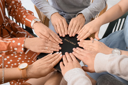 Group of young people prayi...