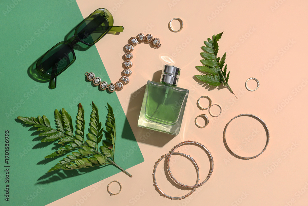 Obraz premium Composition with stylish female accessories, bottle of perfume and fern leaves on color background