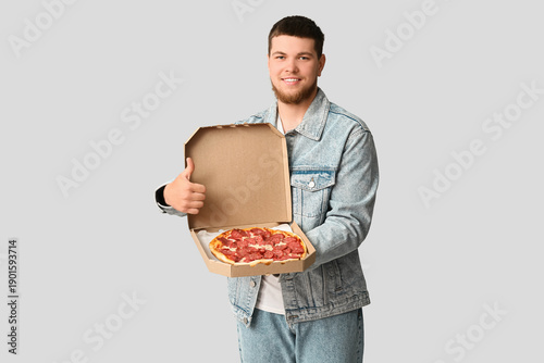 Young man holding cardboard...